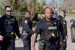 Harris County Sheriff's officers clear the media from the neighborhood where 42-year-old Shamsud-Din Bahar Jabbar is believed to have lived.