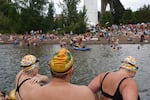 Swimmers stand on the new dock at Cathedral Park in Portland, Ore., on June 29, 2024. A celebration was held for the new dock, in part to increase interest in recreating in the Willamette River.