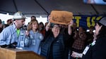 State Sen. Betsy Johnson, D-Astoria, holds up a wood cutting depicting the statehouse at a Timber Unity rally in front of the Oregon Capitol in Salem, Ore., Thursday, Feb. 6, 2020. Johnson opposes the cap-and-trade bill.