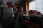 Larry Krause opens the blinds at his home in Eagle Creek, Ore., on Friday, Dec. 19, 2025.