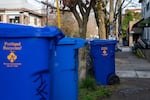 Recycling bins sit on the sidewalk in Portland, Ore., on Feb. 10, 2026.
