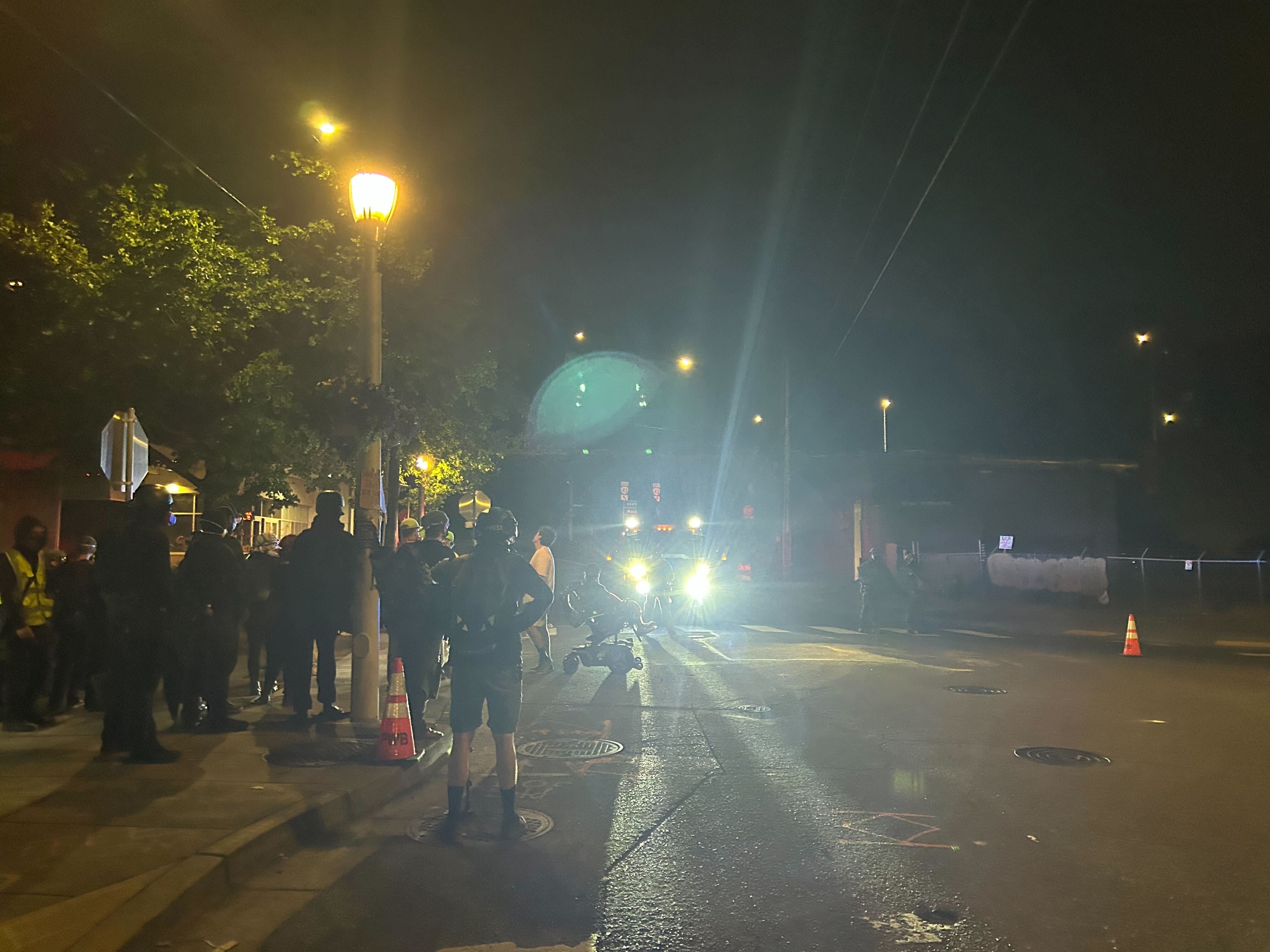 Dozens of protesters gathered outside the U.S. Immigration and Customs Enforcement office in Portland on Tuesday afternoon and into the early hours Wednesday morning, in opposition to the Trump administration’s immigration enforcement policies.