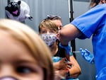 Finn Washburn, 9, receives an injection of the Pfizer-BioNTech COVID-19 vaccine in San Jose, Calif., in November. Now the pharmaceutical companies are seeking authorization to give kids a booster dose of the vaccine.