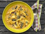 A bowl of silky roasted winter squash bisque with homemade noodles — better than butternut squash ravioli.