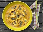 A bowl of silky roasted winter squash bisque with homemade noodles — better than butternut squash ravioli.