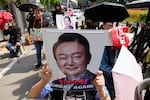 A supporter of former South Korean President Yoon Suk Yeol holds up his portrait during a rally outside of the Seoul High Court in Seoul, South Korea, Wednesday, April 29, 2026.