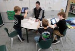 Paraeducator Aaron Nusbaum, center, works with elementary students at Washington School for the Deaf in Vancouver on Nov. 13, 2024.