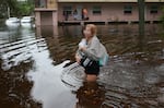 Makatla Ritchter wades through flood waters after having to evacuate her home when the flood waters from Hurricane Idalia inundated it on August 30, 2023 in Tarpon Springs, Florida.