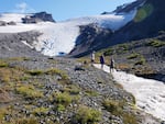 Researchers for the Nooksack Tribe document the flow of Sholes Creek from the Sholes Glacier on Mount Baker.