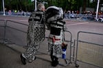 A Pearly King and Queen line the Procession Route in London.