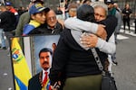 Supporters of Venezuelan President Nicolás Maduro embrace in downtown Caracas