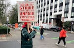 Ella Meloy, a bargaining committee representative for the New Seasons Labor Union, leads picketers outside the store on North Williams Avenue on Nov. 27, 2024, in Portland, Ore. Unionized New Seasons workers went on a one-day strike at 11 Portland-area stores the day before Thanksgiving.