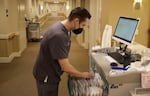 Kevin Heinrich, a licensed practical nurse, at a workstation at Mirabella Portland’s skilled nursing facility on Feb. 13, 2023. Nurses and other health care workers have become increasingly hard to find after the pandemic.