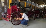 A worker fixes a wheel on one of the electric carriages that Cartagena’s municipal government has imported from China.