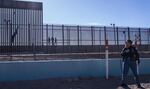 A U.S. law enforcement officer stands guard by a fence along the U.S.-Mexico border at El Paso, Texas.