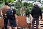 Masked residents watch an activist in Nouméa on Wednesday.