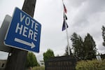 A sign points to a ballot box in downtown Bend, May 19, 2020. 