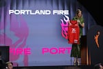 WNBA commissioner Cathy Engelbert holds a Portland Fire jersey after selecting Iyana Martin Carrion, of Spain, seventh overall in the first round of the WNBA basketball draft, Monday, April 13, 2026, in New York.