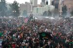 FILE - Members of a crowd numbering tens of thousands smoke marijuana and listen to live music at the Denver 420 pro-marijuana rally at Civic Center Park in Denver, April 20, 2013.