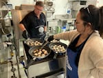 Tacoma-based seafood company owners Jim and Mona Stone prepare scallops to serve to taste testers at the OSU Food Innovation Center in Portland.