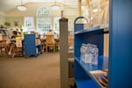 Free water bottles and community resources stand at the entrance to the Belmont Library in Portland on Aug. 14, 2023.