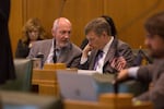 Oregon state Rep. Bill Post, R-Keizer, (left) speaks with Mike McLane, R-Powell Butte, in the House Chamber in Salem, Ore., on Tuesday, April 30, 2019.