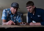 Maritime Technology instructor Colton Edmiston, left, helps first-year student Noah Williamson in Vancouver, Wash., on Aug. 27, 2026. The students are building to-scale models of an 800-foot tanker as part of the program. 
