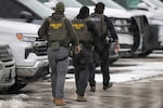ICE agents depart the Bishop Henry Whipple Federal Building on February 4, 2026 in Minneapolis.