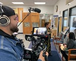 Gabriann "Abby" Hall speaks with Sandy Mosttler about the Klamath Tribes' boarding school experiences, while cinematographer LaRonn Katchia films.