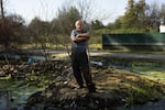 Volodymyr Artemchuk shovels a path through debris for water to drain out of the village of Demydiv, where Ukrainian forces purposely caused a flood to deter the Russian invasion of Kyiv. In August, months later, residents were still dealing with the repercussions of the flood.