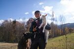 Mikhailo Bilak holds two lambs while their mother looks on.