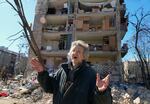 A man reacts standing near his house ruined after Russian shelling in Kyiv, Ukraine, Monday, March 21, 2022. At least eight people were killed in the attack. (AP Photo/ (AP Photo/Efrem Lukatsky)