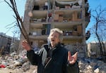 A man reacts standing near his house ruined after Russian shelling in Kyiv, Ukraine, Monday, March 21, 2022. At least eight people were killed in the attack. (AP Photo/ (AP Photo/Efrem Lukatsky)