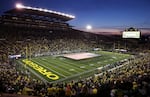 FILE: The Oregon Marching Band displays a giant United States flag on the field at Autzen Stadium before a football game against Colorado, Oct. 11, 2019, in Eugene, Ore.