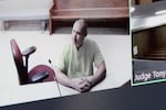 Arson suspect Aaron Farinacci waits for his initial court appearance by video at the county courthouse in Spokane, Wash., Tuesday, Aug. 4, 2026, (AP Photo/Young Kwak)
