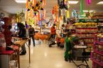 Customers shop while Yamely Chavez Kennedy buils her ofrenda at Colima Market in Bend, Ore., on Oct. 30, 2024.