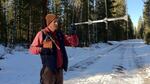 Bilogist John Stephenson uses an antena to try to locate the radio collar signal from wolf Oregon-7. 