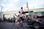 A group of men play Rigsketball, an annual basketball tournament played on a hoop bolted to the back the touring van of Portland-based band And And And. Bim Ditson, the drummer of And And And and former Portland mayoral candidate, created Rigsketball.