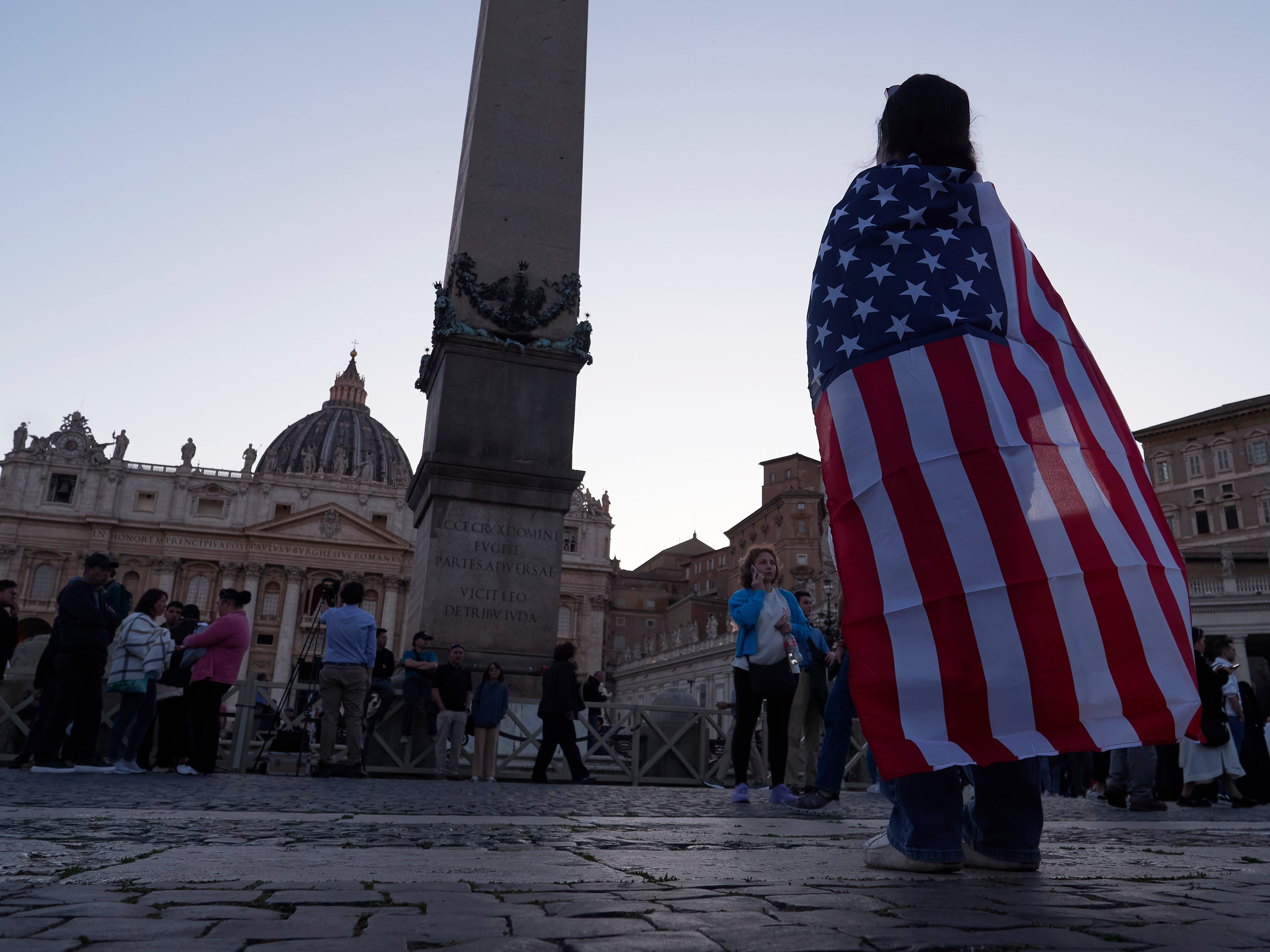 Andrea Gallardo, 20, from Texas, wears an American flag after Pope Leo XIV appeared on the balcony of St Peter's Basilica following his election, at the Vatican, Thursday, May 8.