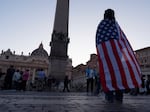 Andrea Gallardo, 20, from Texas, wears an American flag after Pope Leo XIV appeared on the balcony of St Peter's Basilica following his election, at the Vatican, Thursday, May 8.