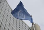 The flag of the International Atomic Energy Agency flies in front of its headquarters during an IAEA Board of Governors meeting in Vienna, Austria.