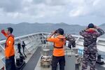 In this photo made from video released by Makassar Search and Rescue Office on Thursday, July 16, 2026, rescuers scan the horizon as they search for victims after a passenger boat sank in the waters near Selayar Island in South Sulawesi, Indonesia.