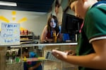 Brooklyn Burnett, sales manager at Walmart, helps a customer on April 20, 2026 in Portland, Ore. BizTown shops include a sports store, a pet adoption center and a cafe.