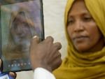 Fatouma Zahara Hasan, a widow with a large family from the town of Chifera, has her photograph taken on a tablet as part of a vast registration drive to ensure that food aid funded by the United States in parts of Ethiopia is only provided to recipients that qualify.