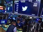 Traders gather around a post as Twitter shares resume trading on the floor at the New York Stock Exchange in New York, on Oct. 4, 2022.