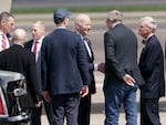 President Joe Biden is greeted by U.S. Sens. Ron Wyden and Jeff Merkley and other members of an Oregon delegation as he arrives at Portland’s airport, April 21, 2022. It was his first visit to the state as president.