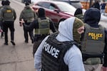 FILE - Masked federal agents conduct immigration enforcement operations Thursday, Feb. 5, 2026, in Minneapolis.