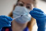 A nurse prepares to administer the Pfizer-BioNTech COVID-19 vaccine at Guy's Hospital in London, Tuesday, Dec. 8, 2020.