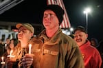 Staff Sgt. Jason Mitchell, a member of the West Virginia Air National Guard, attends a candlelight vigil for Staff Sgt. Andrew Wolfe outside the Berkeley County Sheriff's office on Wednesday in Martinsburg, W.Va.