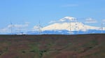 Wind turbines, with Mount Adams in the backdrop. A new report from Stanford researchers says it won't pencil out to store surplus wind power in grid-scale batteries.